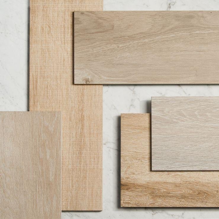 Wood-look and stone tile samples laid out for selection
